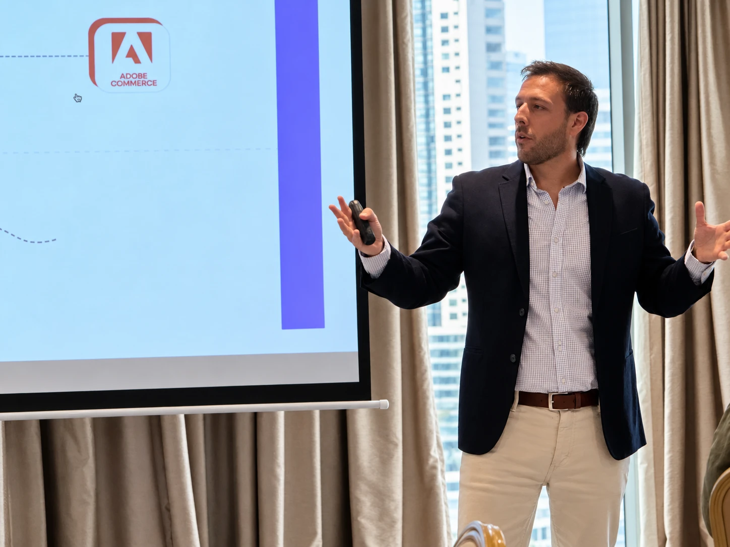 Daniel Segovia standing next to a screen, in the middle of a presentation.