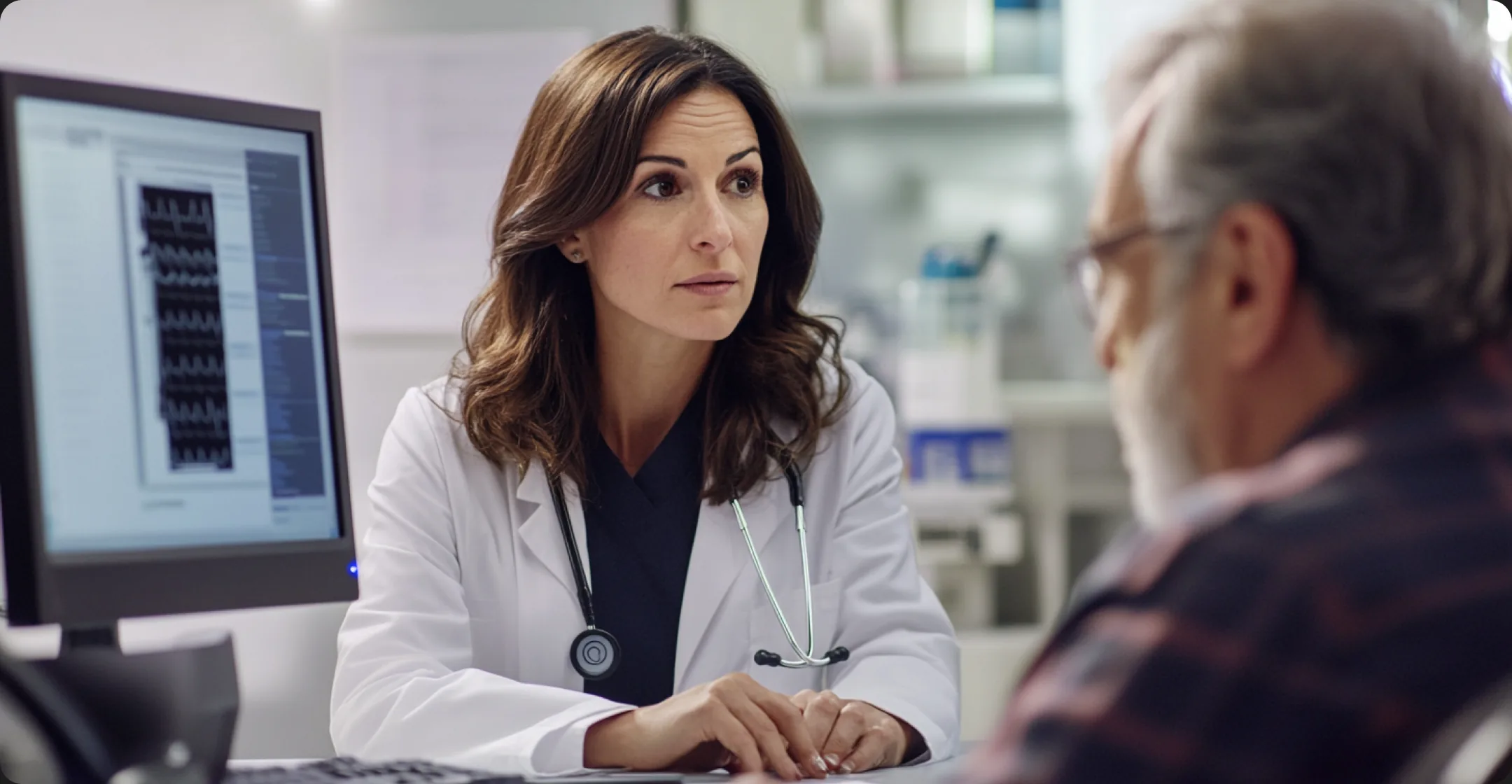 A clinician reviewing patient data with a patient